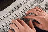 Hands typing at a keyboard
