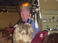 The man playing the bagpipes at midnight