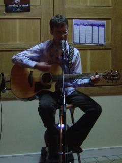 man on stage with guitare